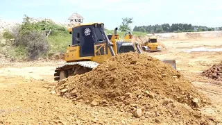 Skills Operator Bulldozer Clearing Spreading Rock Dirt Big Pond Filling Up Dump Truck Unloading Dirt