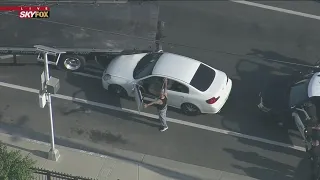 Police chase suspect in custody after being cornered by truck driver mid-pursuit