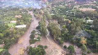 Mud and boulders slide down California hills - aerial video