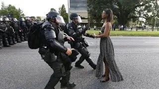 See Powerful Image of Woman Wearing Dress While Facing Police During Protest