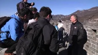 Joe Montana throwing a football on the Great Wall
