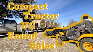 Compact Tractor Moving Round Bales