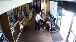 Officer tackles man swinging bat at police station