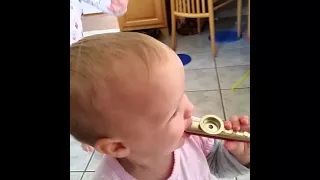 Cute baby playing kazoo