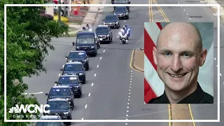 Community members pay respects during procession for Ofc. Joshua Eyer