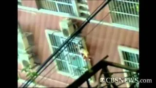 Toddler dangles from sixth floor window