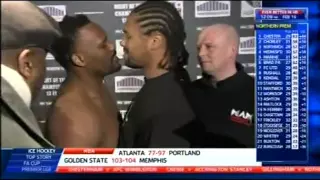 Dereck Chisora kisses Carl Baker during a staredown