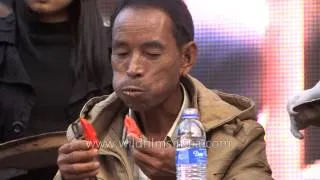 Look at this daring man eat hordes of King Chilly in Nagaland!