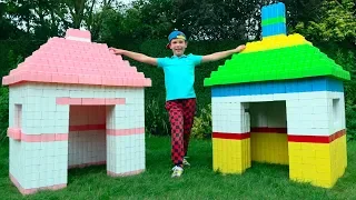 Max and Katy playing with color Playhouses