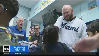 Marlins player hand out back to school supplies