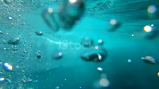 SLOW MOTION UNDERWATER: Crystal clear barrel wave breaking over camera in ocean I STOCK