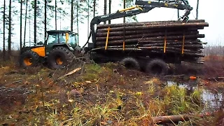 Valtra forestry tractor stuck in mud, difficult conditions in wet forest