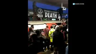 Commuters clash with climate protesters in London tube