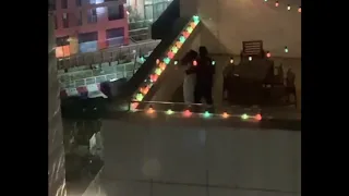 Couple dances on rooftop under stars