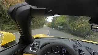 Porsche 718 Spider fast driving in mountains.