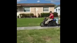 Riding His MoPed On The Sidewalk