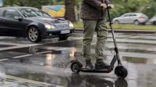 Man on E-Scooter Riding illegally in London Busy Traffic Visually Distracting Drivers