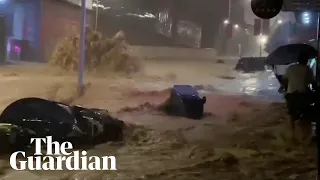 Typhoon Haikui: cars caught up in strong currents of muddy water in China storms