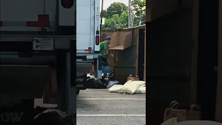 This man was cleaning out the clothing bin and picking at the same time