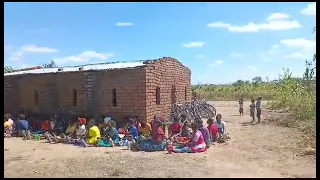 Families Gather for a Service Before Distribution