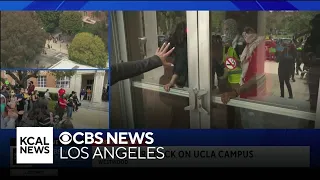 Pro-Palestinian protesters march around UCLA campus and take over Dodd Hall