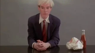 Andy Warhol performing: eating a hamburger 1982