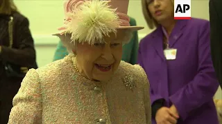 Queen Elizabeth II has puppy playtime at dog charity