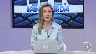 Woman TV News Presenter in Silver Satin Blouse