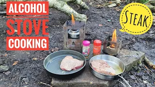 cooking steak on two different alcohol stove In the woodland, Bush box stoves,