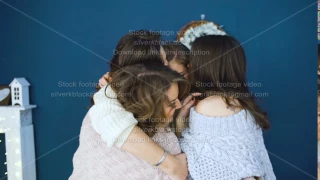 Four beautiful girls hug each other . Girlfriends having fun and laugh in bedroom