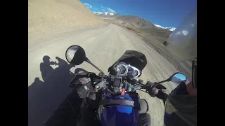 Riding a BMW F650 GS Dakar up the Ak-Baital Pass at 4655 meters altitude in Tajikistan.