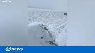 Plane slides off runway at Chicago airport during snowstorm