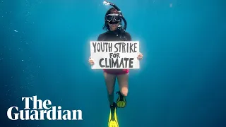 Activist dives for global climate strike in first underwater protest for the planet