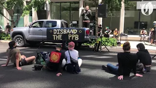 Mayor Ted Wheeler addresses protesters gathered outside his apartment