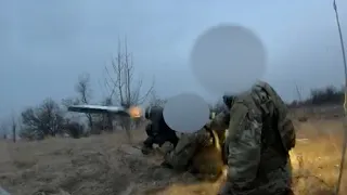 Ukraine soldiers fire a FGM-148 Javelin anti-tank missile system at a Russian armored vehicle