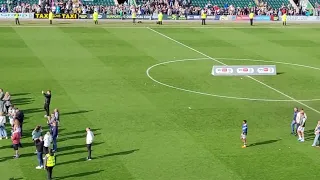 Janner Song, players and families on pitch after promotion Argyle v Burton Albion 2023