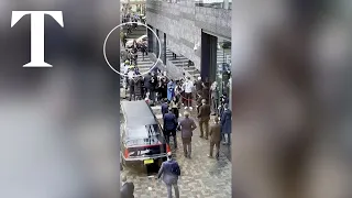 Police tackle protester running towards Macron in Amsterdam