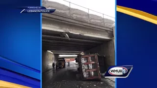 Truck driver charged after crashing into bridge, police say