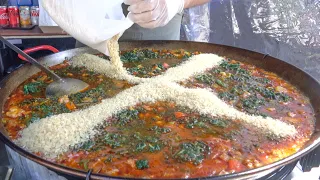 Spanish Paella with Pork, Sausages, Rice and Spinach. London Street Food