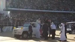 A child running towards the Pope