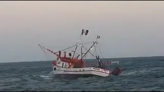 Casting a shrimp fishing net aboard a big boat  - Deep sea trawling