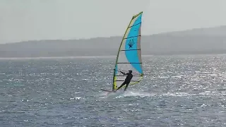 Progressing sailors attempt windsurfing carve gybe