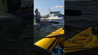 Responding police boat accelerating in front of kayaks - Itiwit X500, Kokopelli Moki Lite, Stockholm