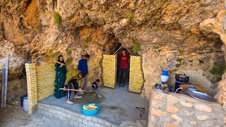 Amir and his family build a brick wall with an iron door around their cave to survive the winter.