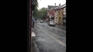 man painting in pissing down rain Lower Breck Road liverpool