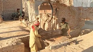 Very Amazing starting up the black old diesel engine working on wood cutter machine