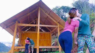 Happy girl kisses her boyfriend for helping make a beautiful house