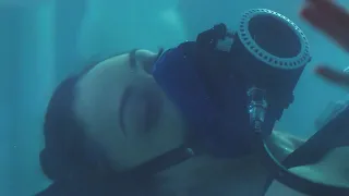 Women with oxygen mask in ice water!