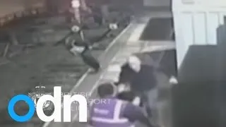 SHOCKING CCTV: Footage shows man pushing police officer onto train tracks