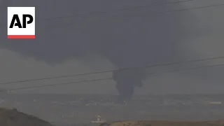 Large smoke plume climbs into sky over Gaza Strip